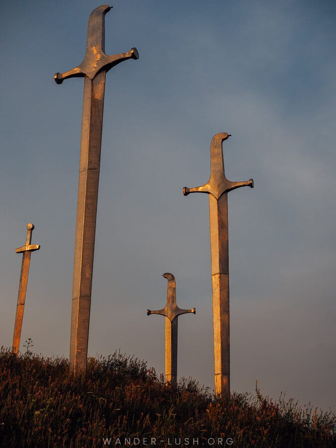 Four large metal swords at Didgori reflects the evening sun.