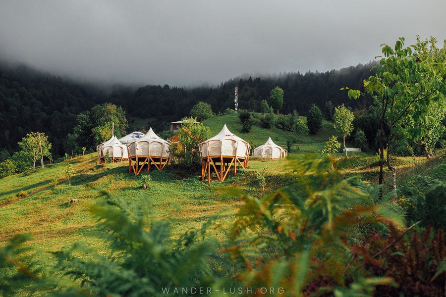 View of Glamping Tago tents, with grey storm clouds gathering overhead.