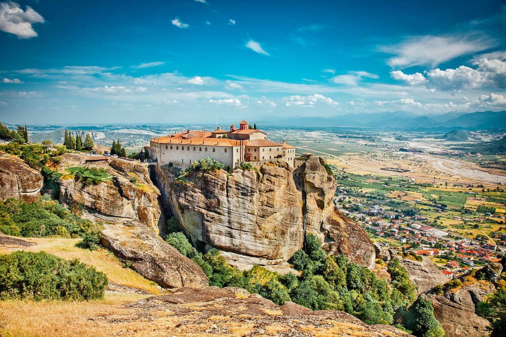 A monastery sits atop a tall rock formation in Meteora, Greece.