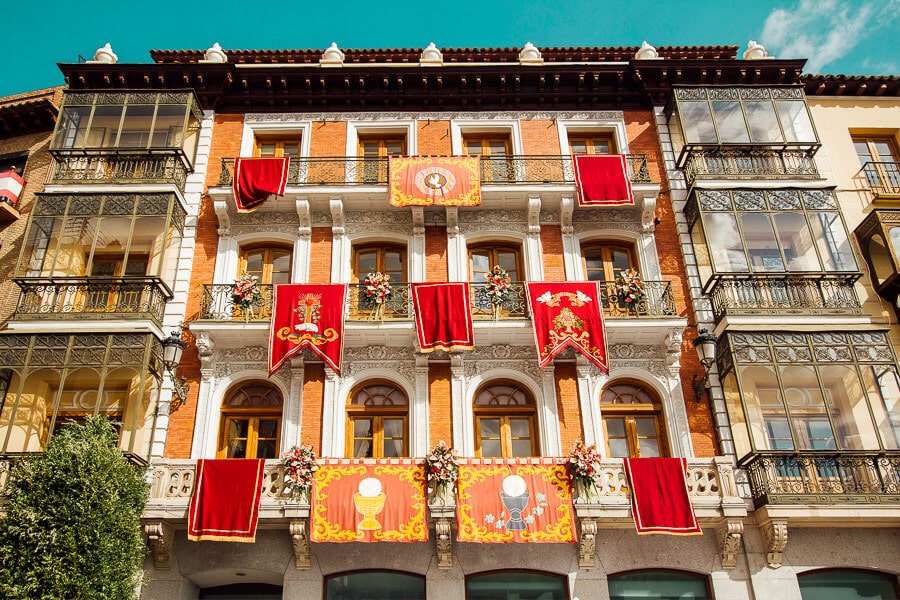 Colourful banners decorate a historic building in Toledo's Plaza Zocodover.