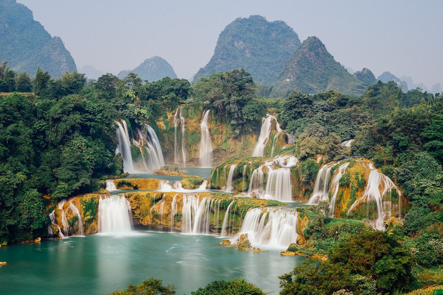 Water cascades over the three-tiered Detian Ban Gioc Waterfalls in Vietnam.