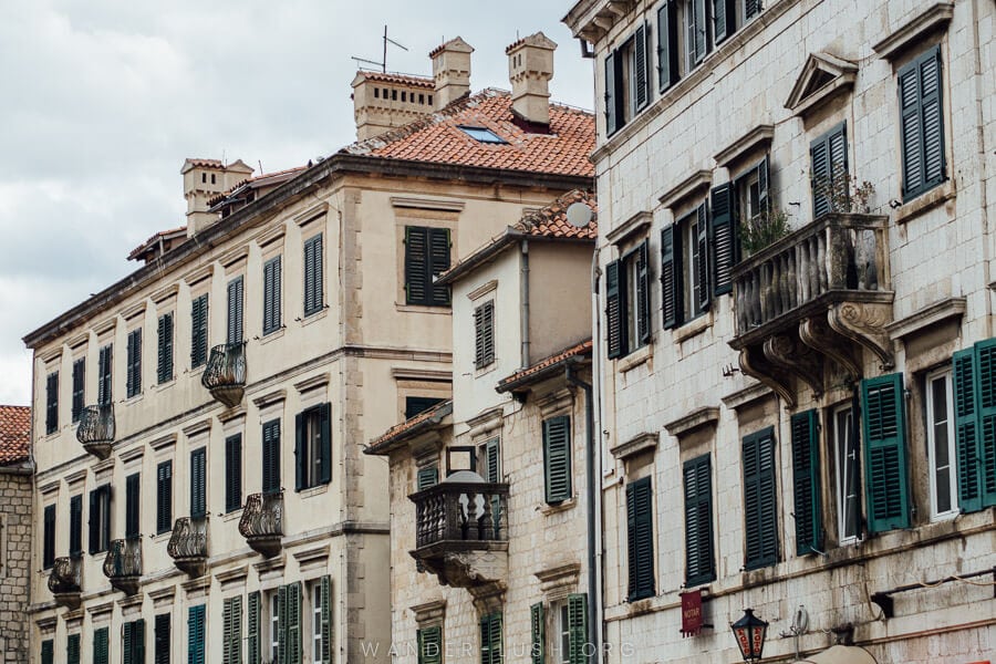 Beautiful buildings with wooden shutters in Kotor Old Town in Montenegro.