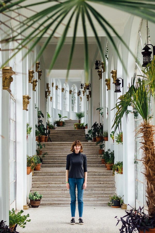 A woman stands inside the restored White Corridor at Tskaltubo Spa Resort.