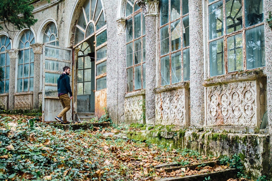 A man walks into an old abandoned sanatorium in Tskaltubo, Georgia.
