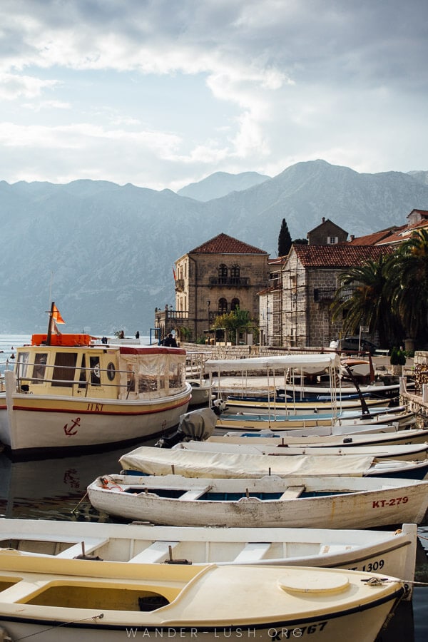 A row of small boats on the seafront in Perast.