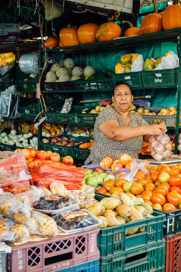 A woman sells fruit at a market in Medellin.
