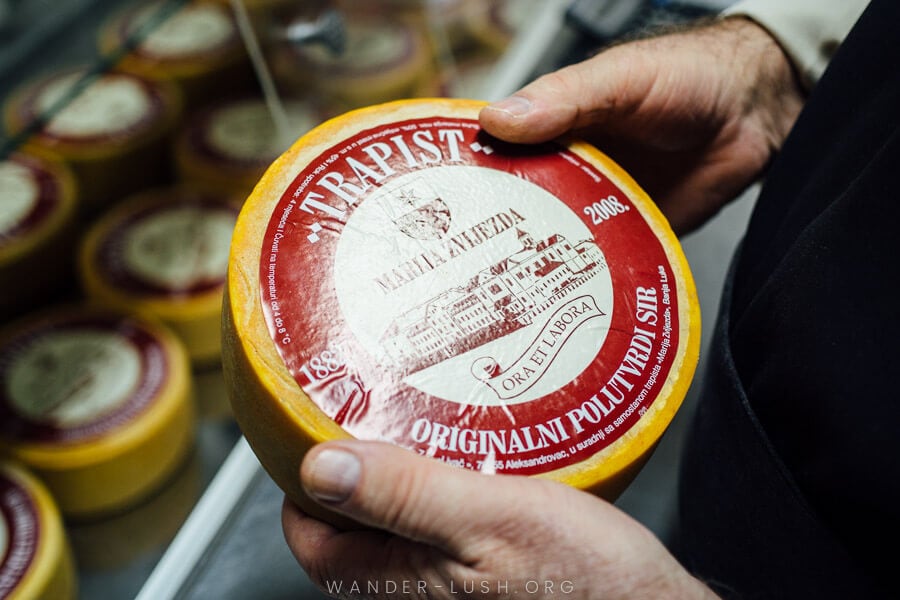 A monk holds a wheel of Trappist cheese at a monastery in Banja Luka, Bosnia and Herzegovina.