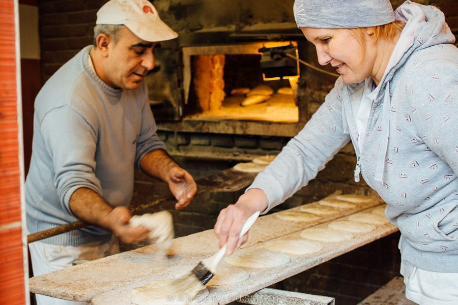 Two people make somun Bosnian bread at a bakery in Tuzla, Bosnia and Herzegovina.