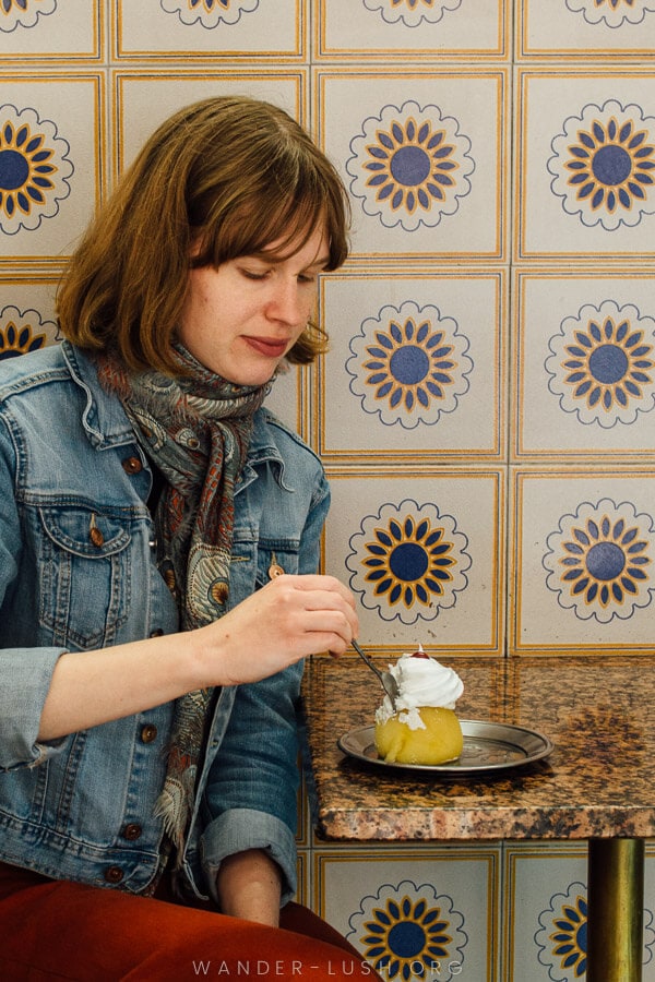 A woman eats a Bosnian tufahija dessert at a cafe in Sarajevo.