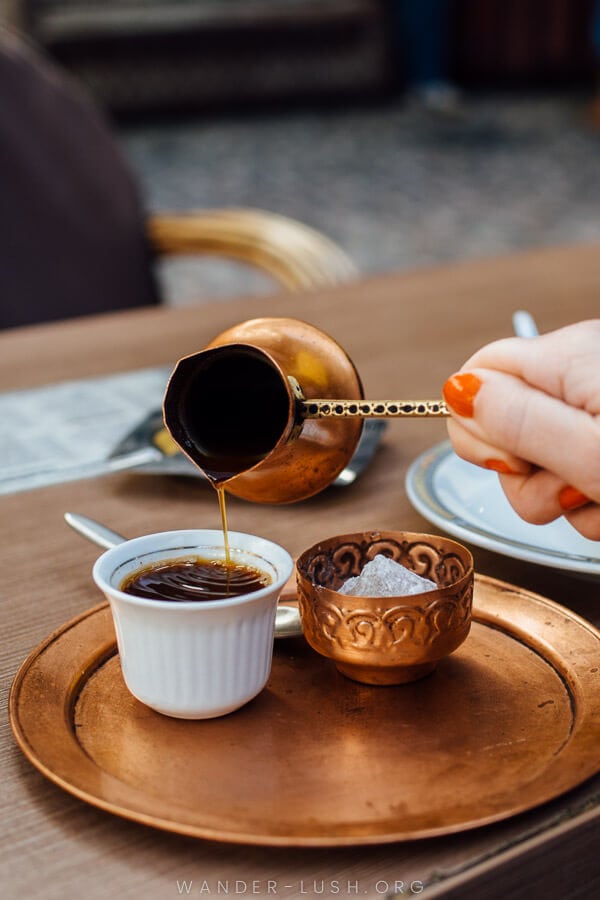 Pouring traditional Bosnian coffee at a cafe in Sarajevo.