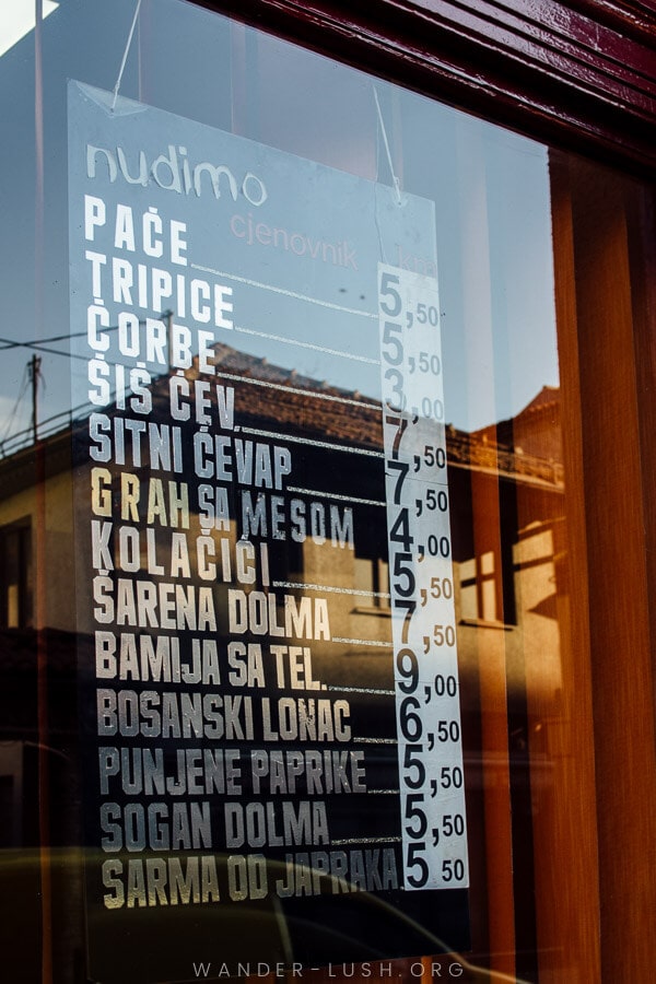 A restaurant in Sarajevo displays its menu in the front window.