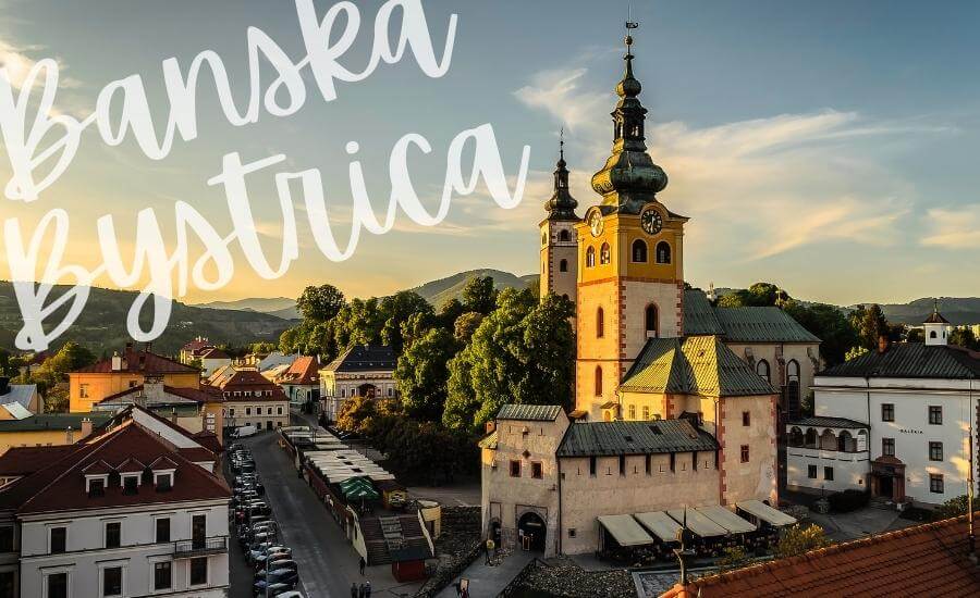 Dusk falls over the church towers in Banska Bystrica, one of the most beautiful places in Slovakia to visit.