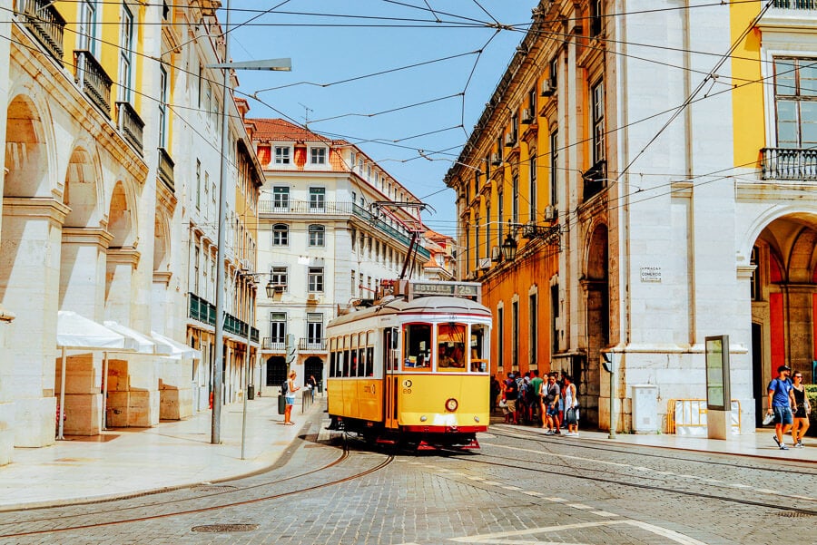 A yellow tram on the street in Lisbon, Portugal.