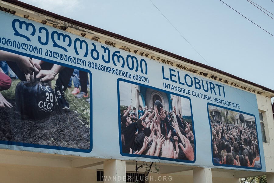 A village building in Guria decorated with a poster showing photos of the Lelo Burti festival.