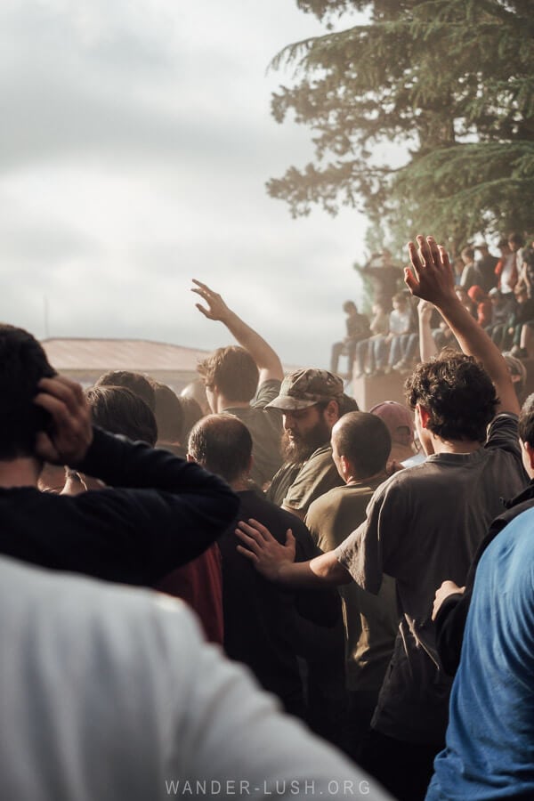 Participants raise their hands and jostle for the ball at Lelo Burti, a traditional festival in Guria.