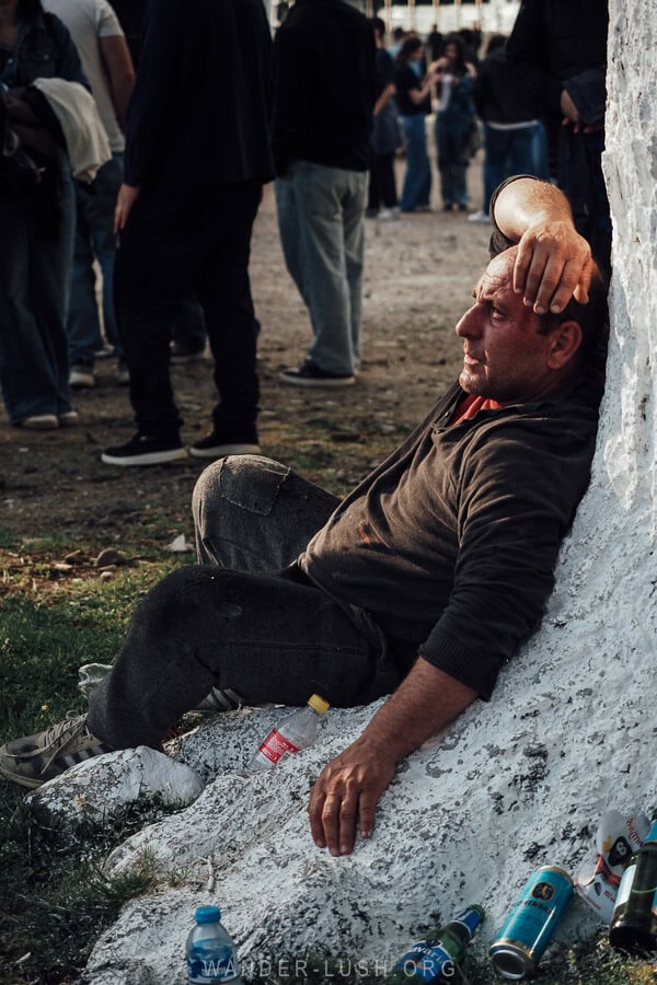 A man sits in the hollow of a tree after being pulled from the crowd at Lelo Burti in Georgia.