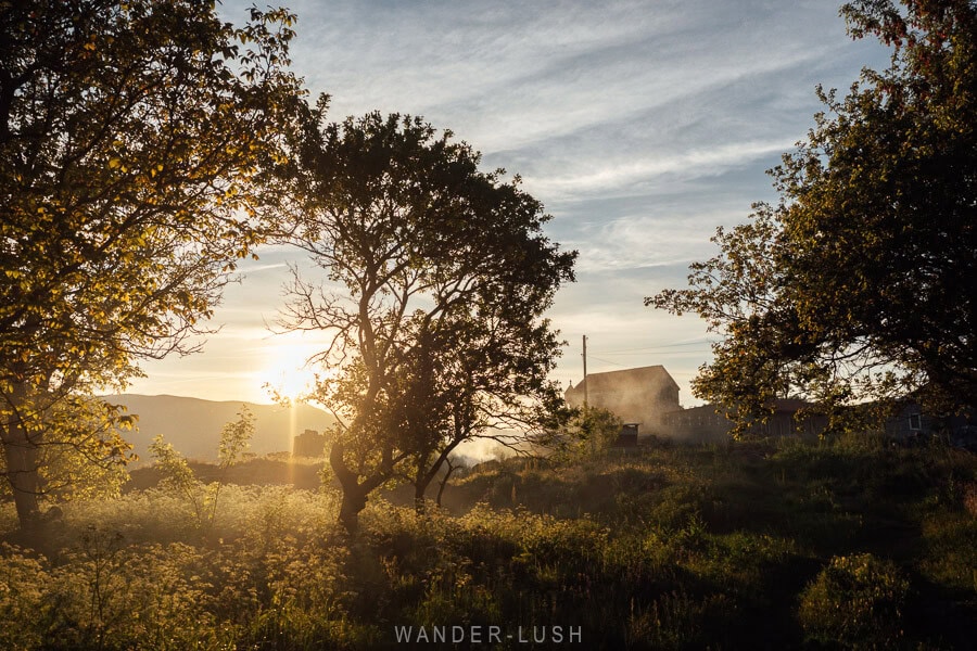 Sunset over a church and trees in the village of Saro in Georgia.