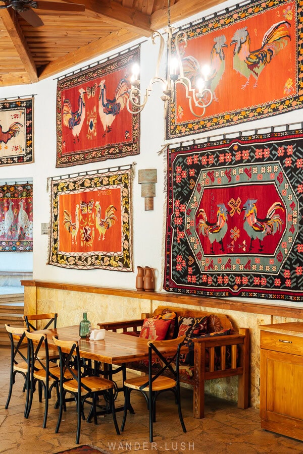 A restaurant interior decorated with colourful antique carpets.