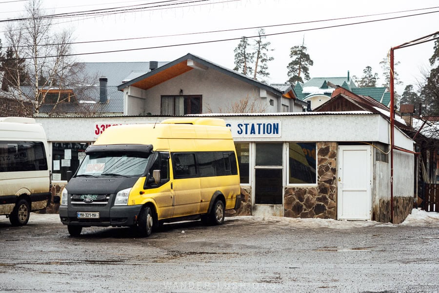 A yellow minivan parked outside Bakuriani Bus Station in Georgia.