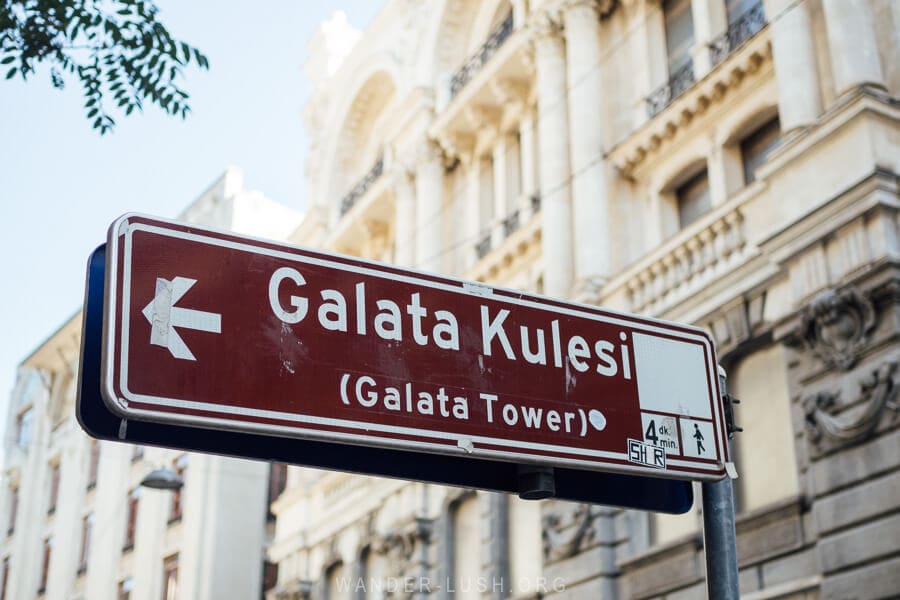 A tourist sign points the way to the Galata Tower, a popular tourist attraction in Istanbul.