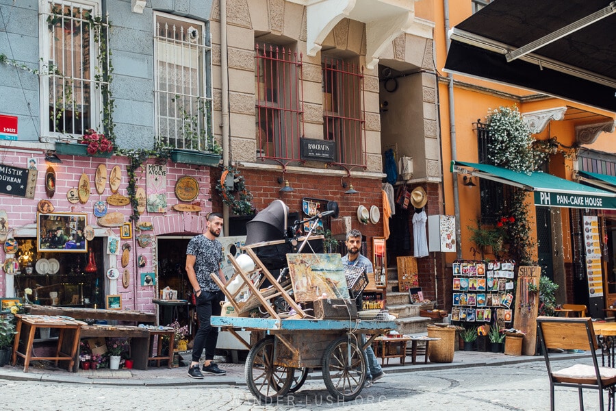 A man pushes a cart piled high with antiques through the streets of Balat in Istanbul.