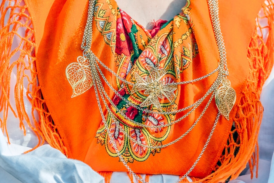 An embroidered scarf and gold filigree jewellery in Portugal.