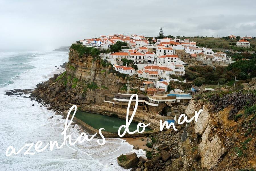 A village of white houses on a sheer cliff above the Atlantic Ocean in the pretty Portuguese town of Azenhas do Mar.