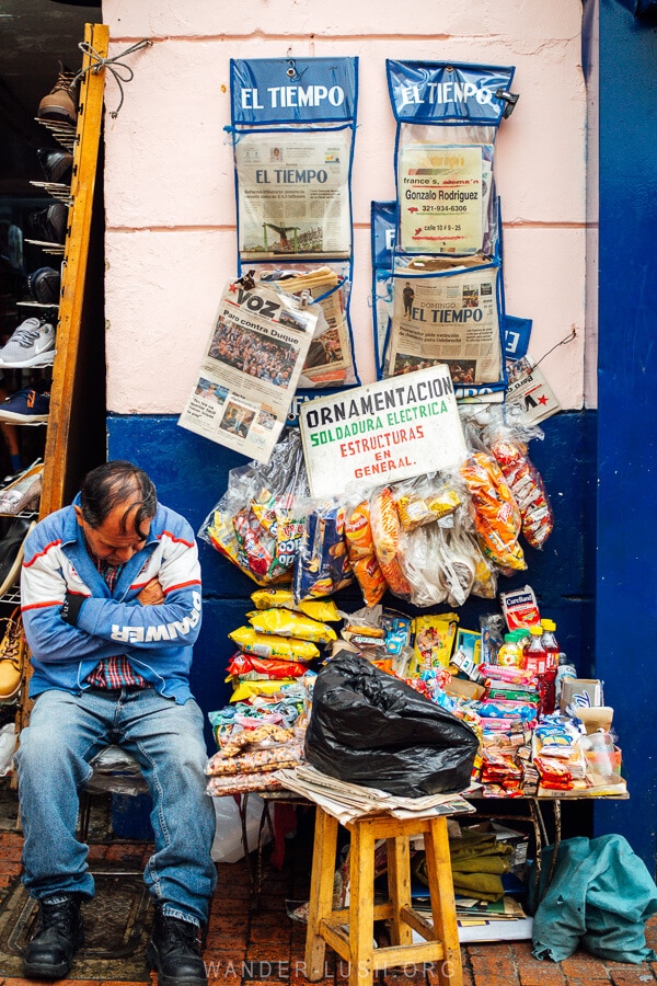 A man sits at a shop in Bogota, Colombia.