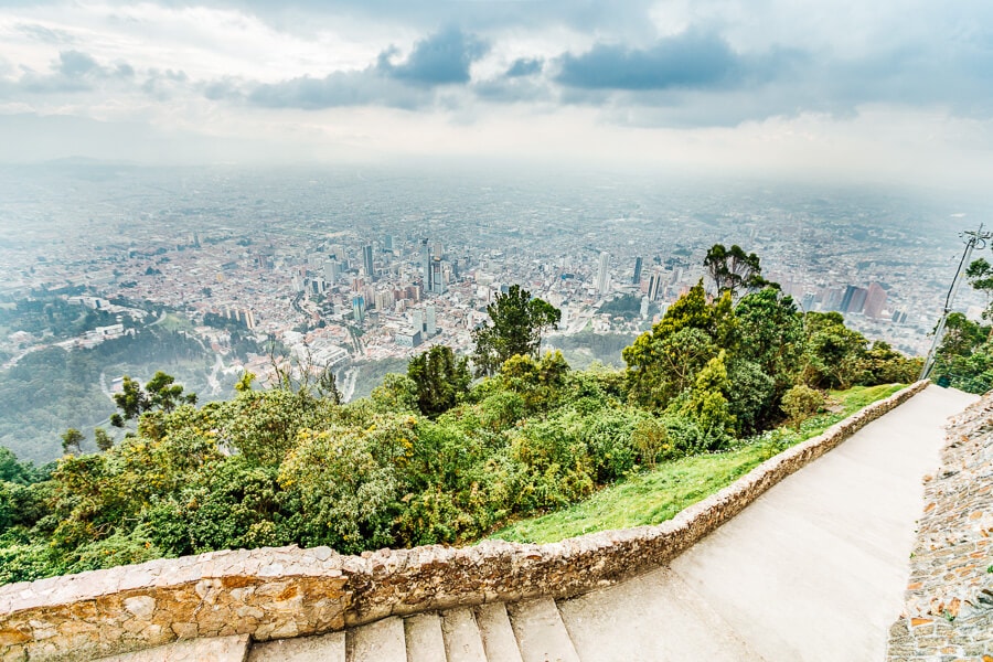 View of Bogota city from Monserrate, with a walking path and forest trail over the city.