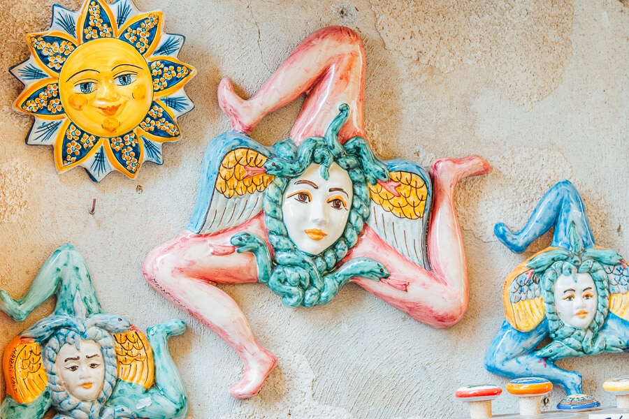Trinacria clay ornaments for sale at a souvenir shop in Sicily.