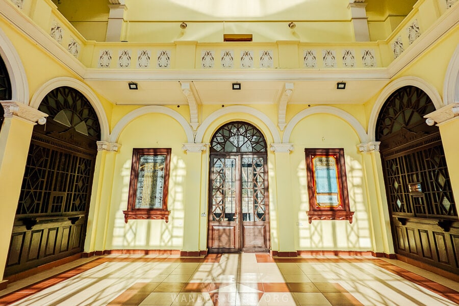 Inside the Borjomi Park Railway Station, a central sunlit atrium painted yellow.