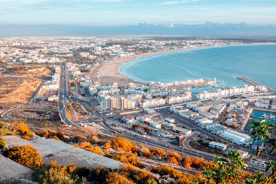 Aerial view of the Moroccan city of Agadir, with the harbour and sea in frame.