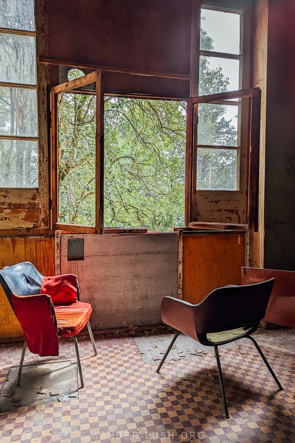 Two chairs in front of a window inside Sanatorium Medea in Tskaltubo.