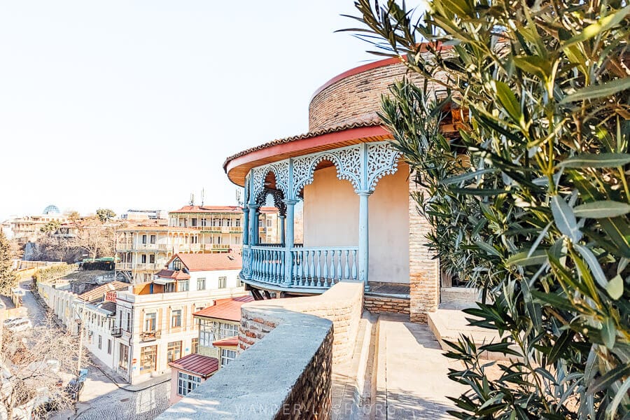 Queen Darejan Palace, a round wooden balcony painted blue looking out over Tbilisi.