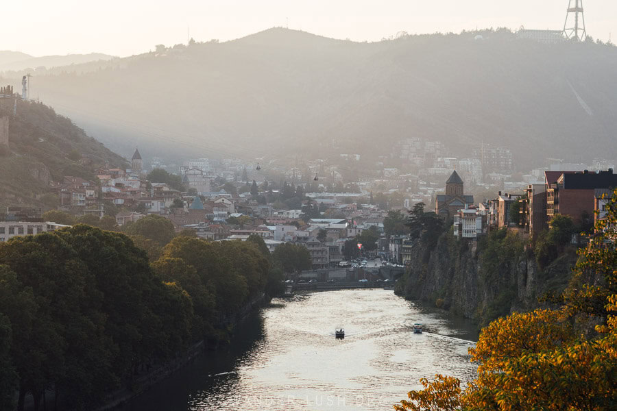 A golden sunset over the Mtkvari River and Old Tbilisi, seen from King Parnavaz Garden.