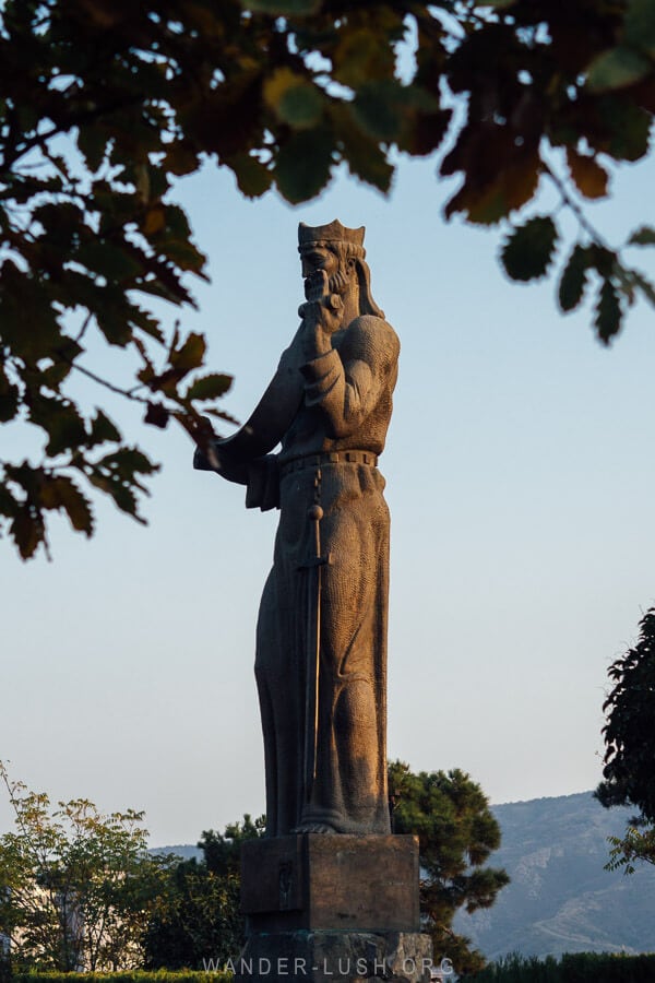 A statue of King Parnavaz stands in Tbilisi at sunset.