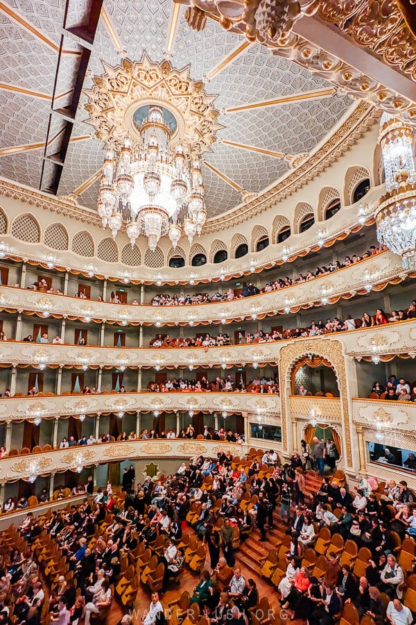 People rush to take their seats inside the opulently decorated Opera Theatre in Tbilisi.