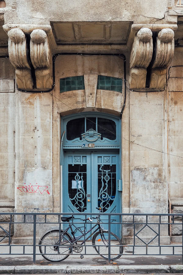 A beautiful blue door with a bike parked in front in a historic neighbourhood in Tbilisi, Georgia.