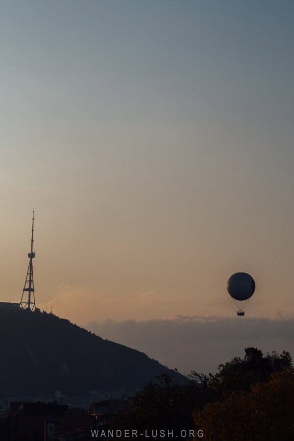 A view of the Tbilisi TV Tower and tethered balloon from Avlabari at sunset.