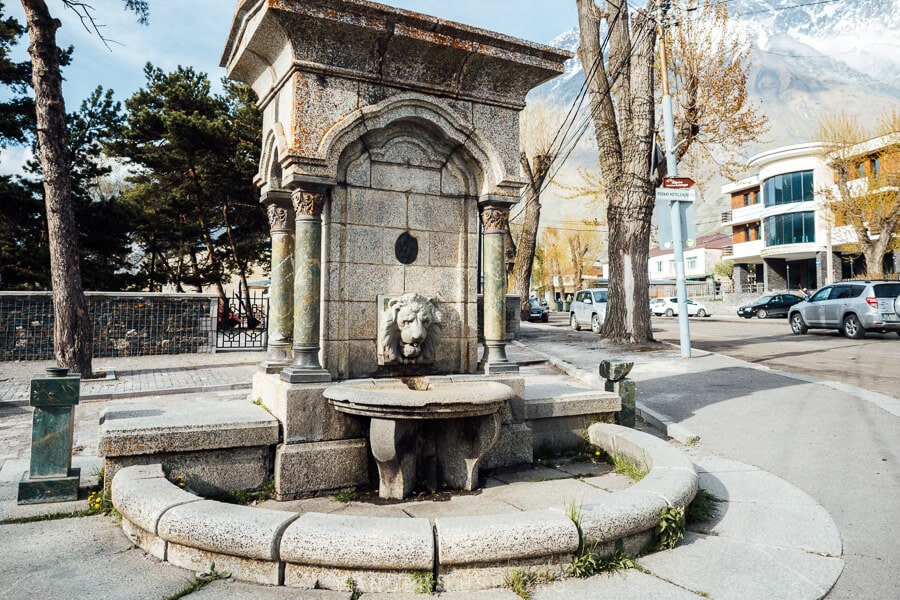 A stone lion fountain in the centre of Kazbegi, a small mountain town in the Greater Caucasus in Georgia.