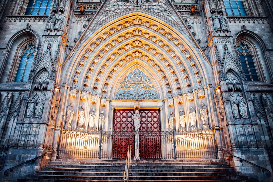 The entrance to the Barcelona Cathedral lit up at night.
