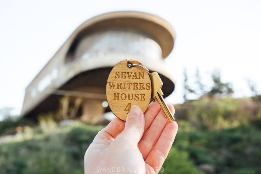 A hand holding a key to the Sevan Writers House hotel in Armenia.