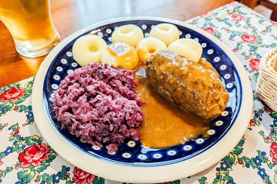 A plate of beef rolada served with red cabbage and Silesian potato dumplings at a restaurant in Katowice.