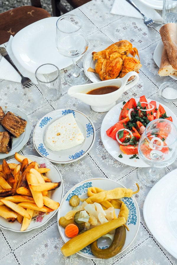 A table laid out with Georgian food - salads, plum sauce and cheese - on a vineyard in Kakheti.