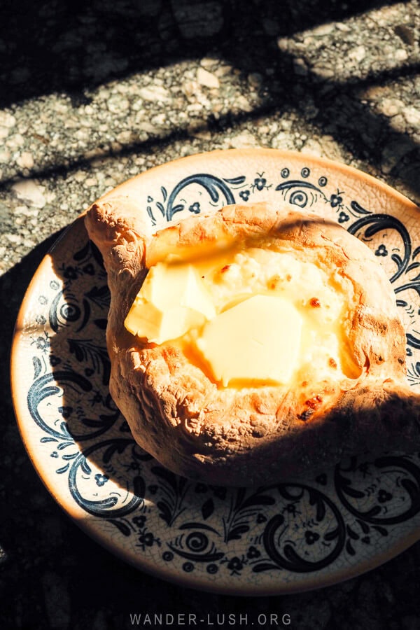An Adjaruli khachapuri, bread with cheese and an egg yolk, served on a stone table at a cafe in Batumi, Georgia.