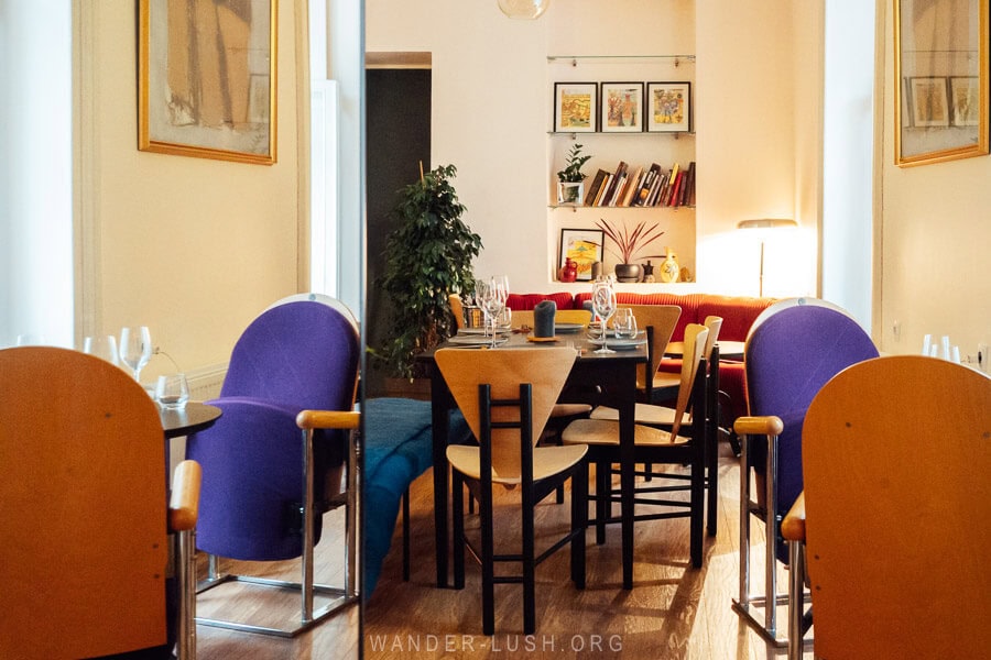 Tables and retro chairs inside Ferment, a classy wine bar and restaurant on Gudiashvili Square in Tbilisi.