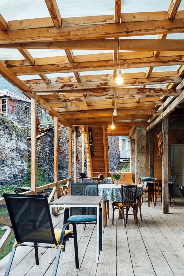 A veranda dining area made of wood at a cafe guesthouse in Ushguli.