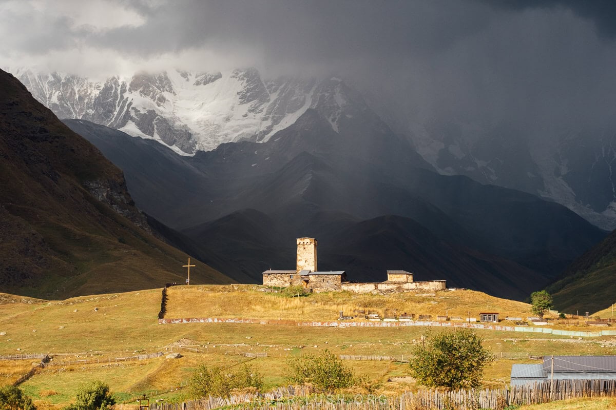 Lamaria Church against a backdrop of mountains in Ushguli, Georgia.