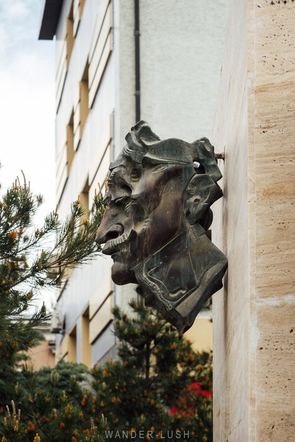 An unusual bronze bust sculpture mounted to a wall in the city of Kaspi, Georgia.
