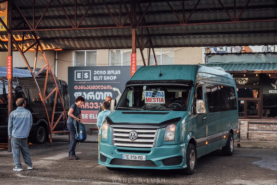 A green marshrutka van at Kutaisi bus station loading passengers for the journey to Mestia.